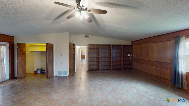 unfurnished living room featuring plenty of natural light and a textured ceiling