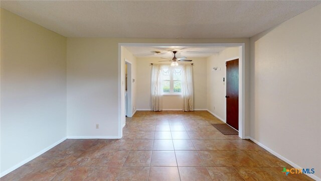 interior space with ceiling fan and a textured ceiling