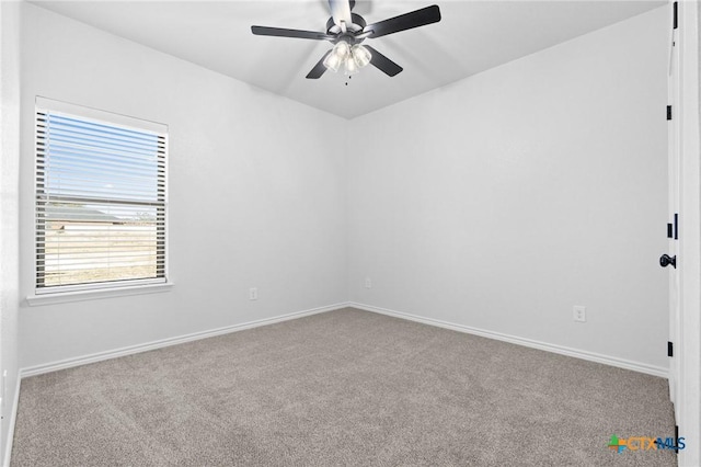 carpeted spare room featuring ceiling fan