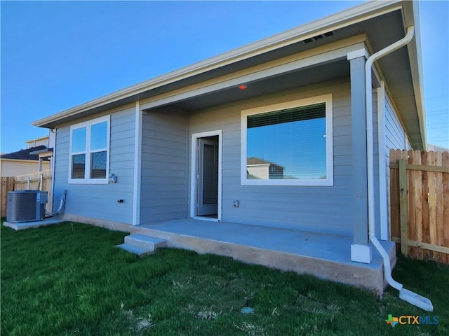 exterior space featuring central AC, a patio, and a front yard