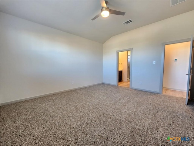 unfurnished bedroom featuring light carpet, vaulted ceiling, and ceiling fan