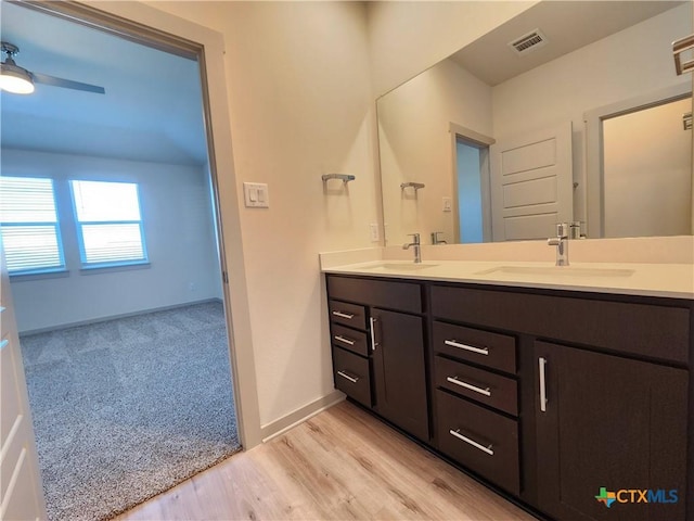 bathroom with vanity, wood-type flooring, and ceiling fan