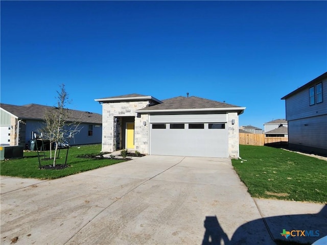 view of front of house with a garage and a front lawn