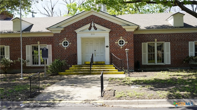 view of front of house featuring brick siding and entry steps
