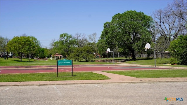 view of property's community with a yard and community basketball court