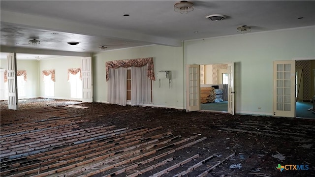 unfurnished room featuring visible vents and beam ceiling