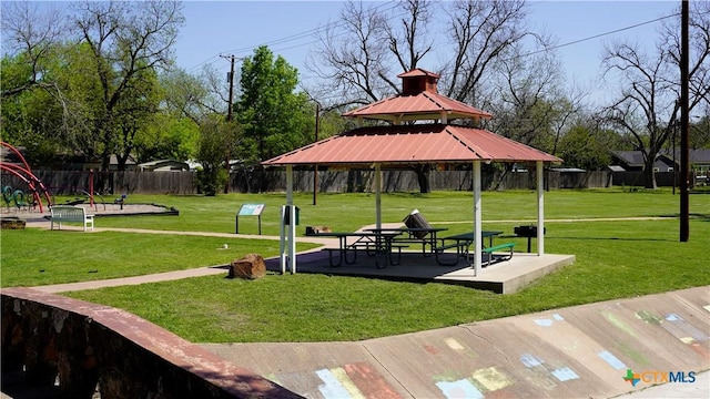 view of community with a gazebo, fence, and a lawn