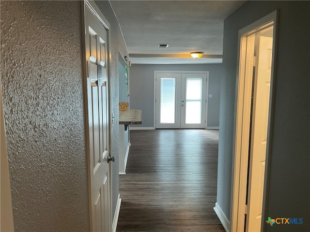 corridor featuring dark hardwood / wood-style flooring and french doors