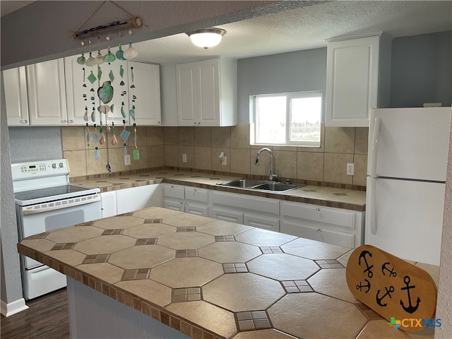 kitchen with white cabinetry, sink, tasteful backsplash, and white appliances