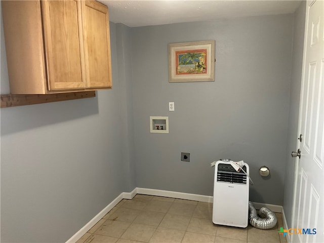 clothes washing area with washer hookup, electric dryer hookup, and cabinets