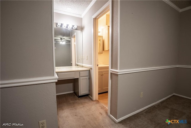 bathroom with ornamental molding and a textured ceiling