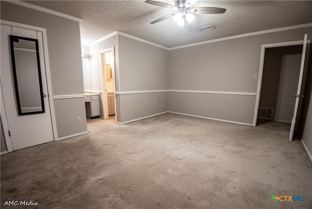 unfurnished bedroom featuring crown molding, light colored carpet, and a textured ceiling