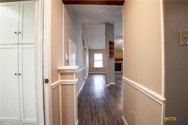 corridor featuring dark hardwood / wood-style floors and a textured ceiling