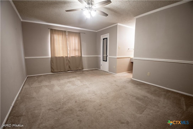 empty room with ceiling fan, ornamental molding, carpet floors, and a textured ceiling