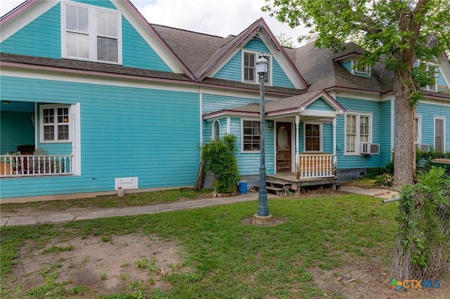 204 Ave F, Shiner, TX 77984 - view of front facade with cooling unit, roof with shingles, and a front yard