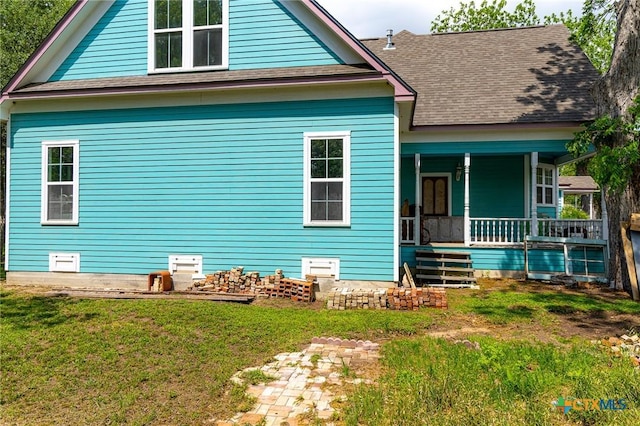 204 Ave F, Shiner, TX 77984 - rear view of property featuring covered porch, a yard, and roof with shingles