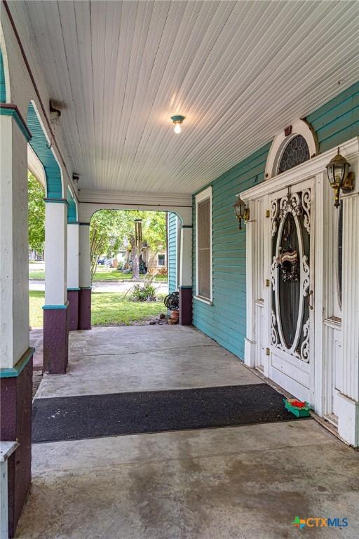 204 Ave F, Shiner, TX 77984 - view of patio / terrace featuring a porch and an attached carport