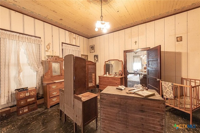 204 Ave F, Shiner, TX 77984 - miscellaneous room featuring wooden ceiling, an inviting chandelier, and wooden walls