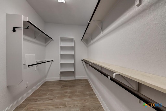 spacious closet with light hardwood / wood-style floors