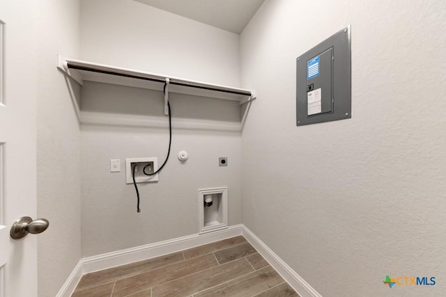 laundry room with washer hookup, electric dryer hookup, wood-type flooring, electric panel, and hookup for a gas dryer