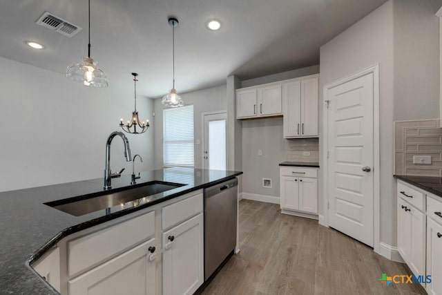 kitchen with dishwasher, sink, tasteful backsplash, decorative light fixtures, and white cabinetry