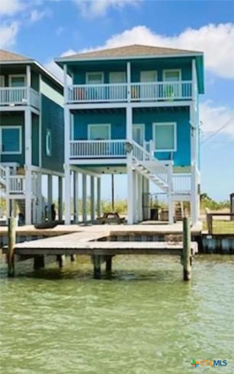 2790 Fm 2031, Matagorda, TX 77457 - back of property with a balcony, stairway, and a water view