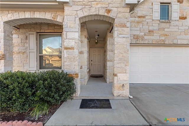 doorway to property with a garage