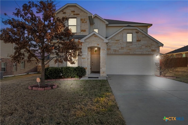 view of front of property featuring a garage and a lawn