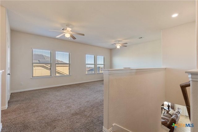 unfurnished room featuring ceiling fan and carpet