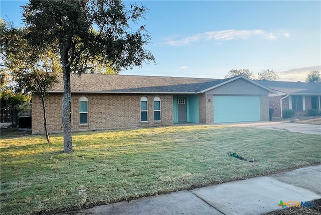 ranch-style home with a front yard and a garage