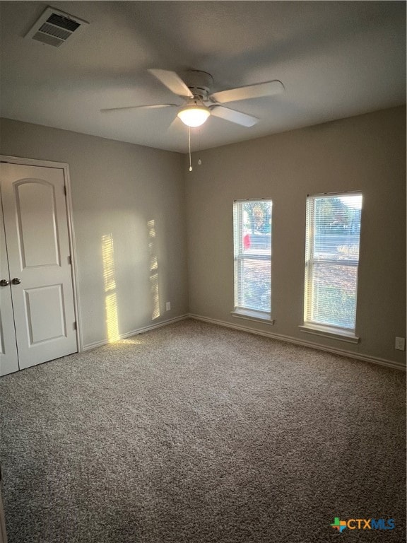 empty room with carpet floors and ceiling fan