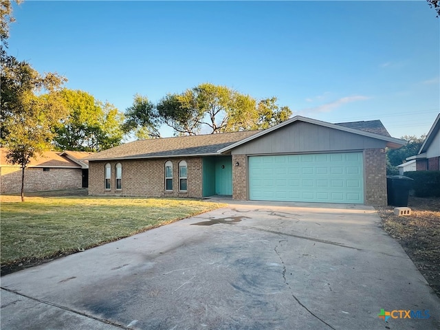 ranch-style home with a front yard and a garage