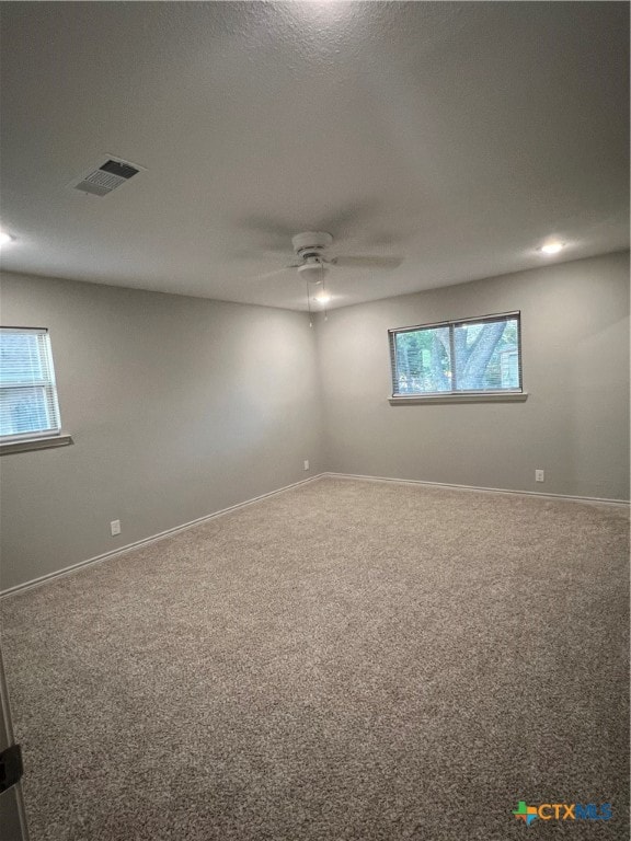 spare room with carpet and ceiling fan