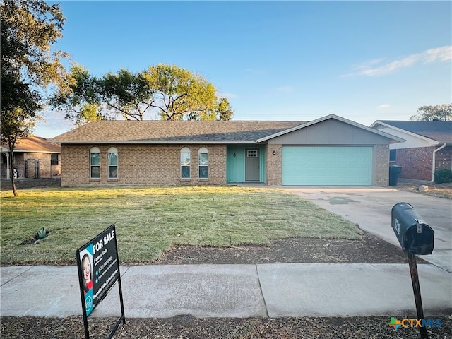 single story home featuring a front lawn and a garage