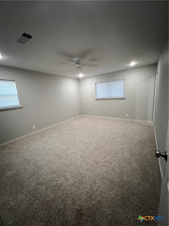 spare room featuring carpet flooring and ceiling fan