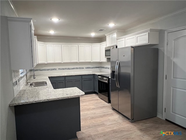 kitchen with light wood-type flooring, stainless steel appliances, crown molding, sink, and white cabinetry