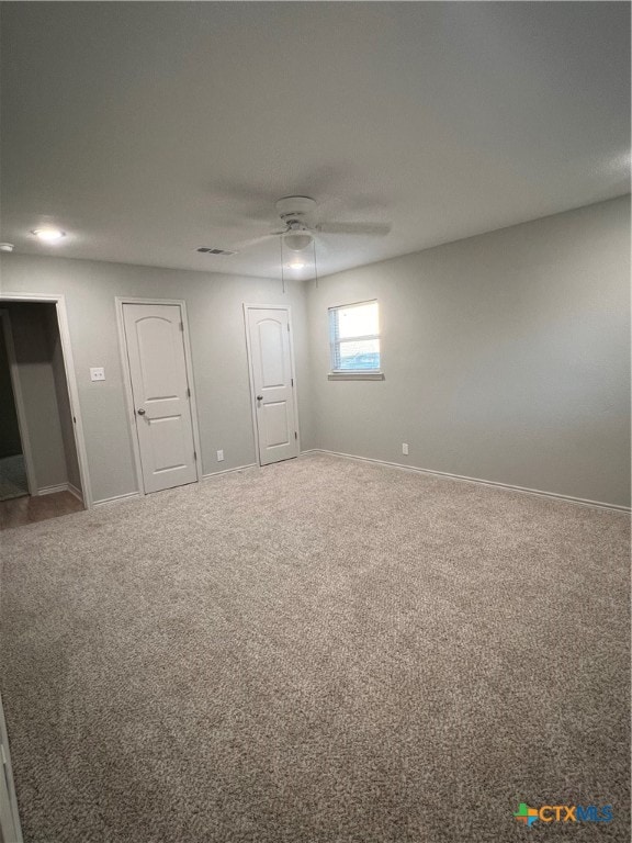 unfurnished bedroom with carpet floors and ceiling fan