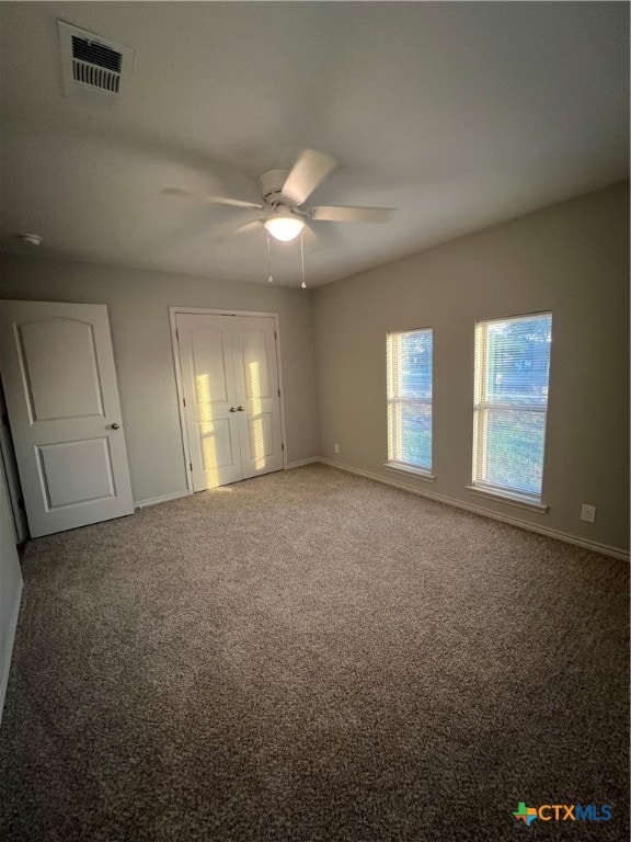 unfurnished bedroom with carpet flooring and ceiling fan