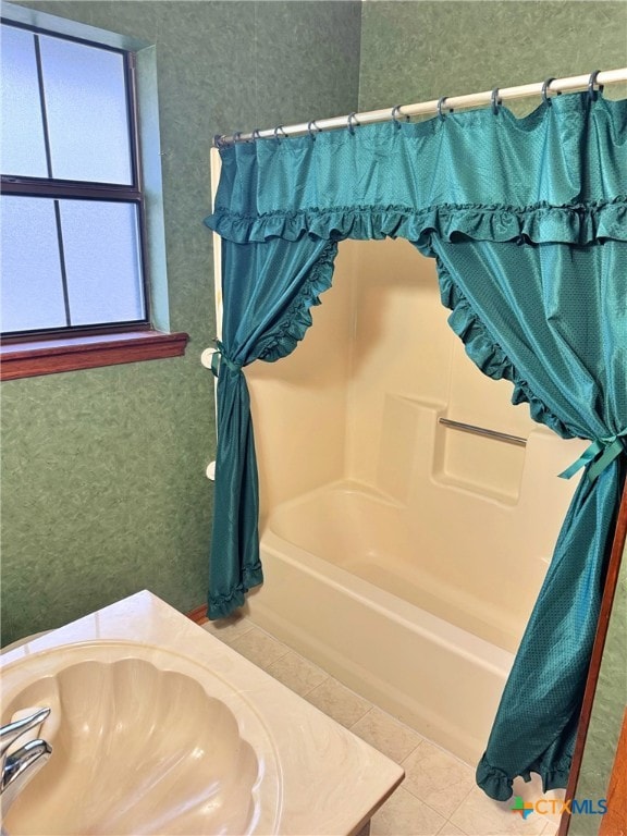 bathroom featuring tile patterned floors, a bathtub, and sink