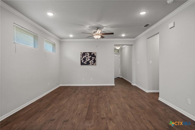 unfurnished room with dark wood-style floors, visible vents, crown molding, and a ceiling fan