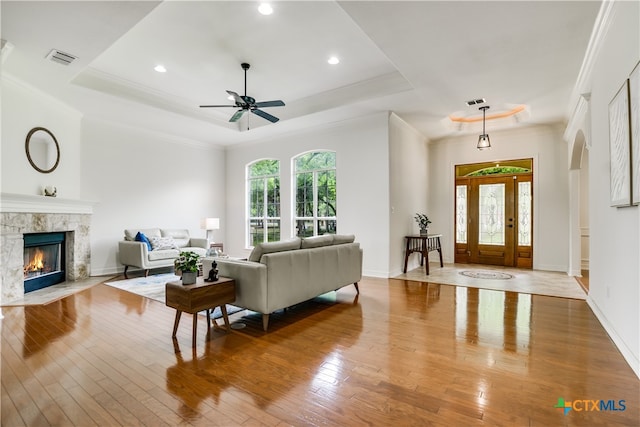 112 Oak Plaza Dr, Georgetown, TX 78628 - living room with a raised ceiling, healthy amount of natural light, hardwood / wood-style flooring, a ceiling fan, and ornamental molding