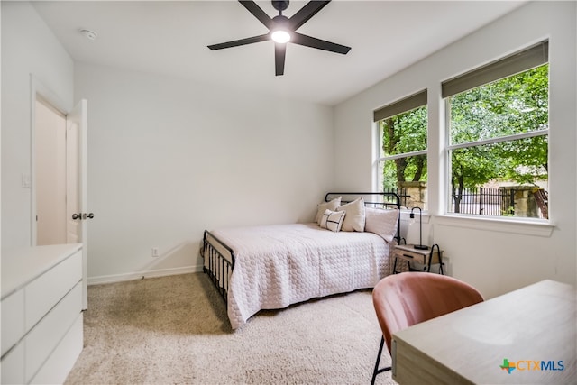 112 Oak Plaza Dr, Georgetown, TX 78628 - bedroom with light carpet, ceiling fan, and baseboards