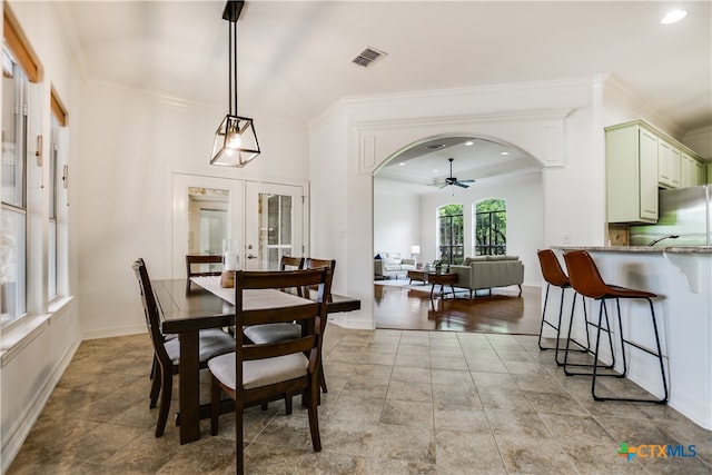 112 Oak Plaza Dr, Georgetown, TX 78628 - dining room with french doors, ornamental molding, recessed lighting, ceiling fan, and arched walkways