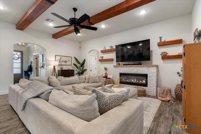 3006 Beulah Blvd, Belton, TX 76513 - living room featuring arched walkways, wood finished floors, baseboards, ceiling fan, and a stone fireplace