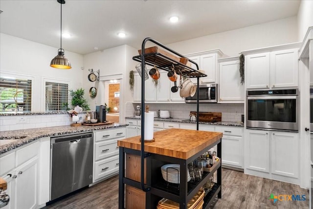 3006 Beulah Blvd, Belton, TX 76513 - kitchen with stainless steel appliances, butcher block counters, white cabinets, tasteful backsplash, and dark wood-style floors