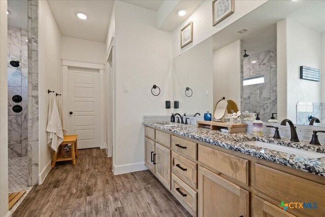 3006 Beulah Blvd, Belton, TX 76513 - full bath featuring a walk in shower, double vanity, wood finished floors, and baseboards