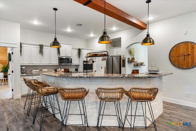 3006 Beulah Blvd, Belton, TX 76513 - kitchen with appliances with stainless steel finishes, a breakfast bar area, baseboards, dark wood finished floors, and beam ceiling