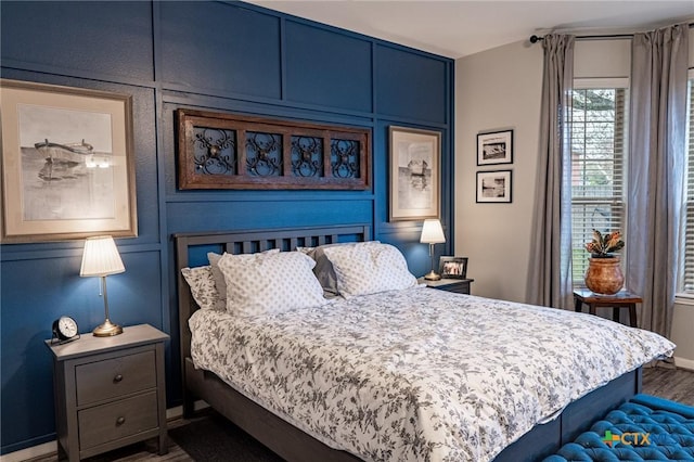 bedroom with hardwood / wood-style flooring