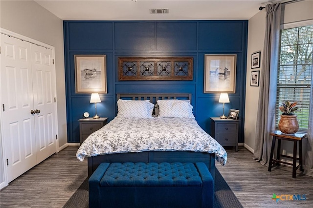 bedroom featuring dark wood-type flooring and a closet