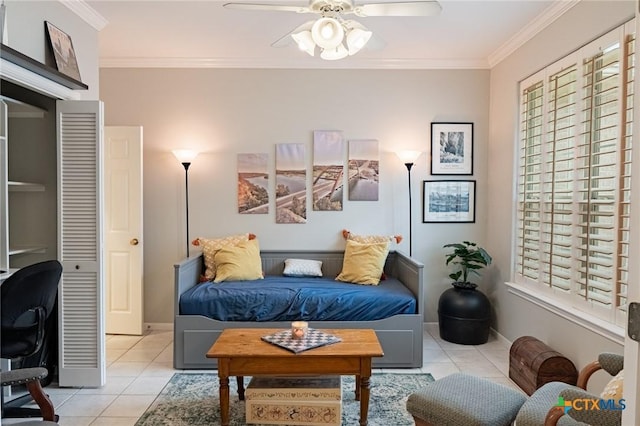 interior space with crown molding, ceiling fan, and light tile patterned floors